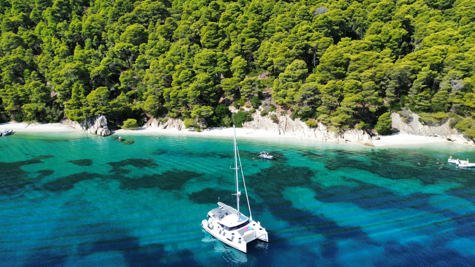 Catamaran anchoring in a quiet Ionian bay